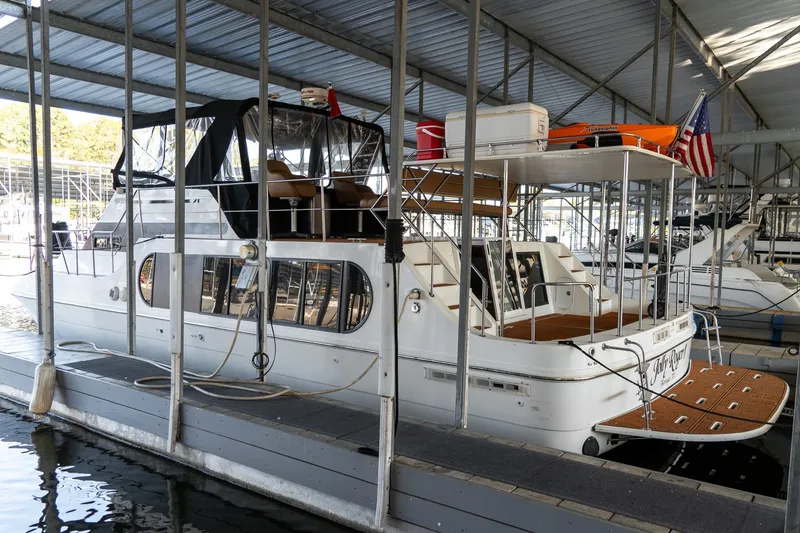 Slide: The Image of 1997 Harbor Master Stolkraft boat docked in a covered marina. - 10