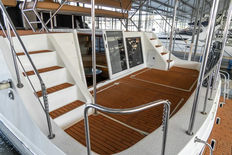 Slide: The Image of 1997 Harbor Master Stolkraft yacht with wooden deck and stairs in marina setting. - 15