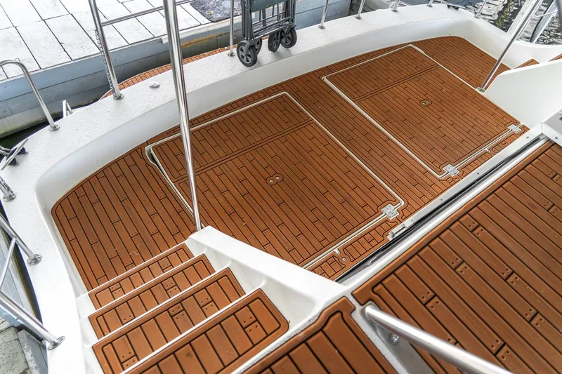 Slide: The Image of 1997 Harbor Master Stolkraft boat deck with wood-patterned flooring and metal railings. - 16