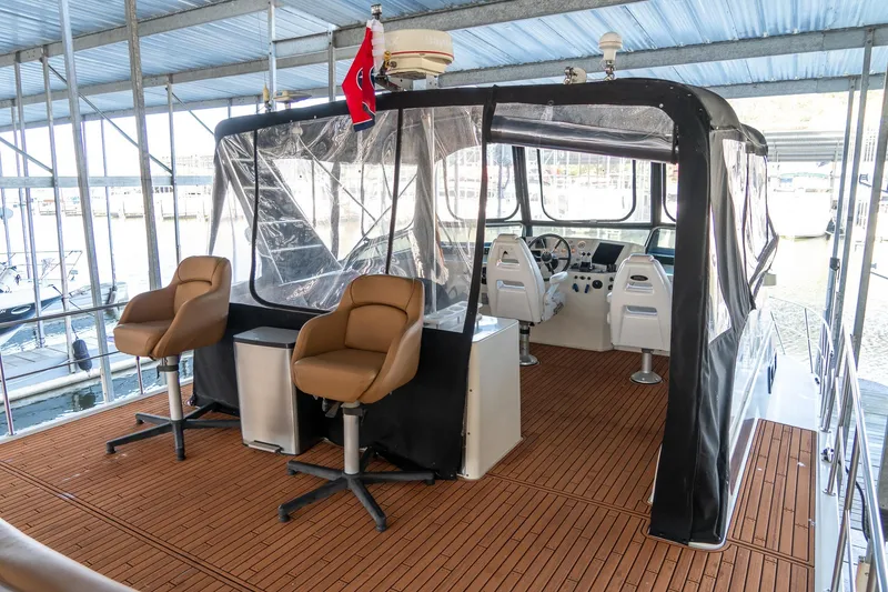 Slide: The Image of 1997 Harbor Master Stolkraft boat interior with seating and helm, docked in a marina. - 19