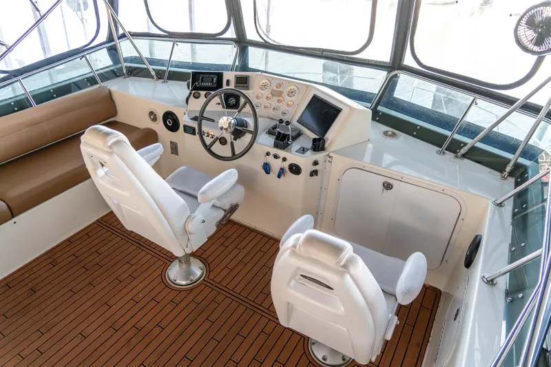 Slide: The Image of 1997 Harbor Master Stolkraft boat interior with helm, steering wheel, and seating. - 23