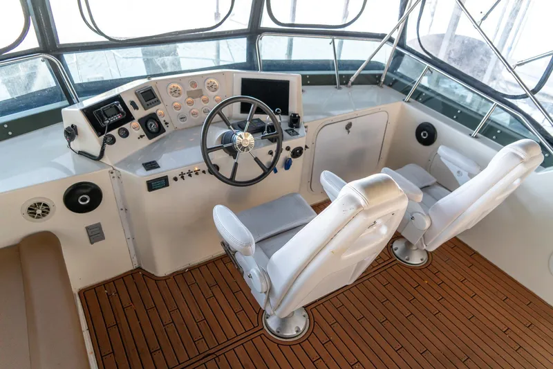 Slide: The Image of 1997 Harbor Master Stolkraft helm with dual seats and modern controls. - 25