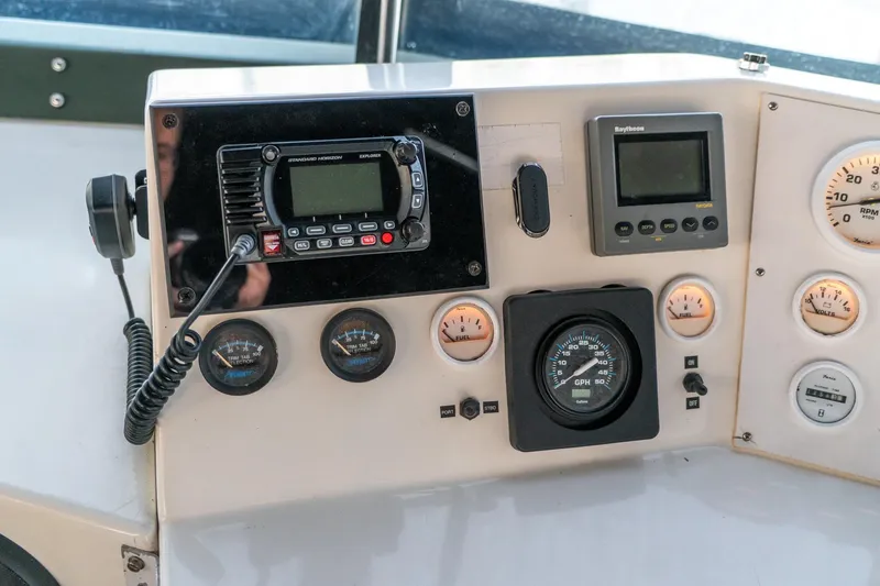 Slide: The Image of Control panel of a 1997 Harbor Master Stolkraft boat with gauges and radio equipment. - 27