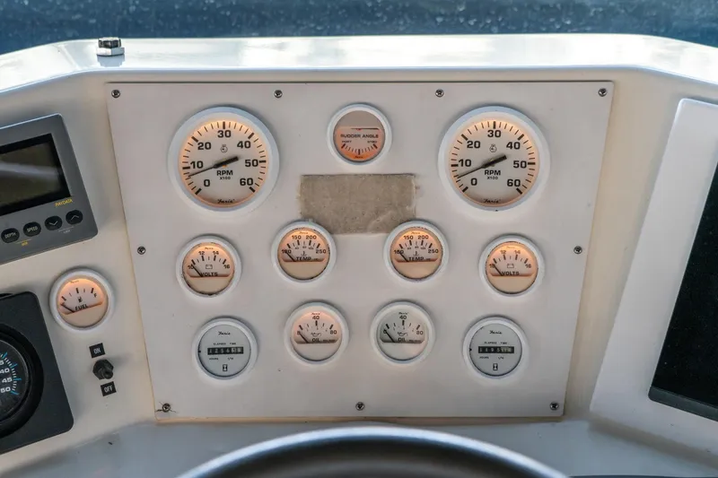 Slide: The Image of Control panel of a 1997 Harbor Master Stolkraft boat with various gauges and dials. - 28
