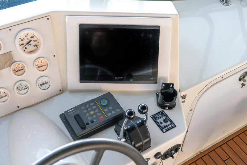 Slide: The Image of 1997 Harbor Master Stolkraft boat dashboard with gauges, controls, and Garmin display. - 29