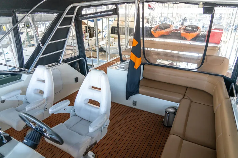 Slide: The Image of 1997 Harbor Master Stolkraft boat interior with seating, steering wheel, and ladder. - 31