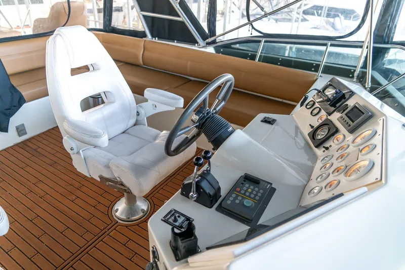 Slide: The Image of 1997 Harbor Master Stolkraft boat cockpit with steering wheel and control panel. - 32