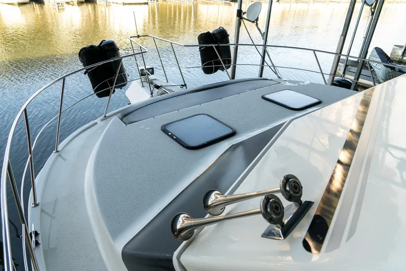 Slide: The Image of 1997 Harbor Master Stolkraft boat deck with railing, docked on calm water. - 34