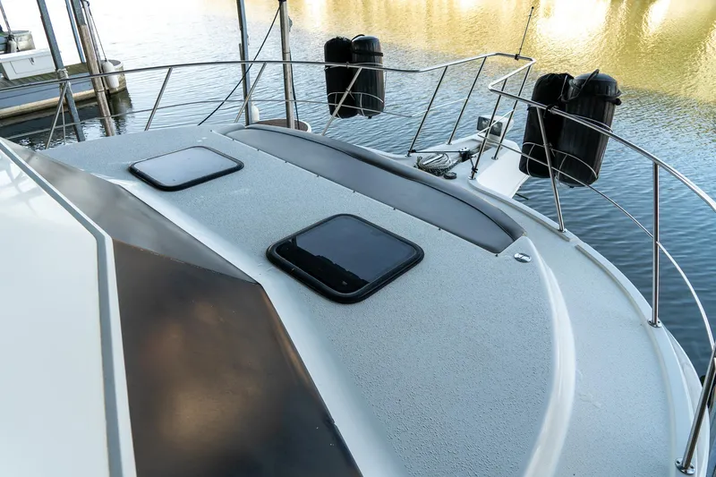 Slide: The Image of 1997 Harbor Master Stolkraft boat deck with hatches, docked on calm water. - 35