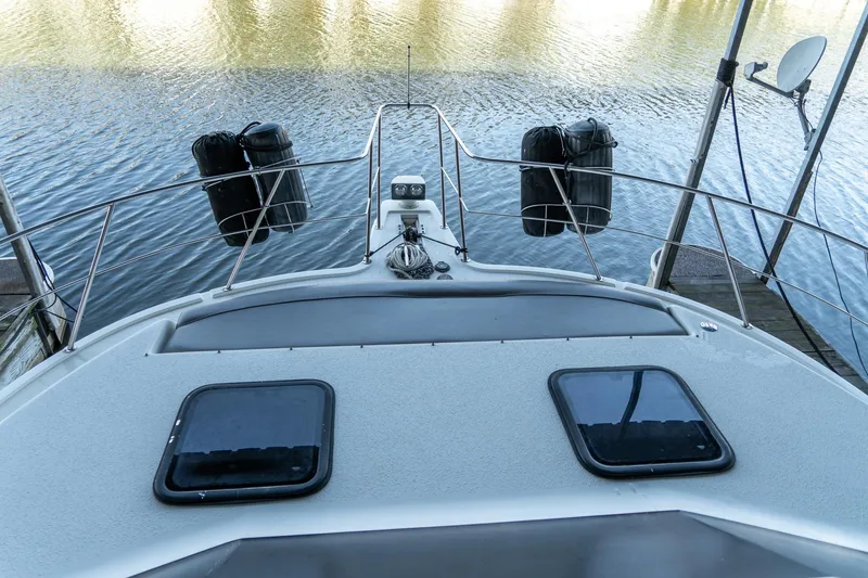 Slide: The Image of 1997 Harbor Master Stolkraft boat deck with water view and docked fenders. - 36