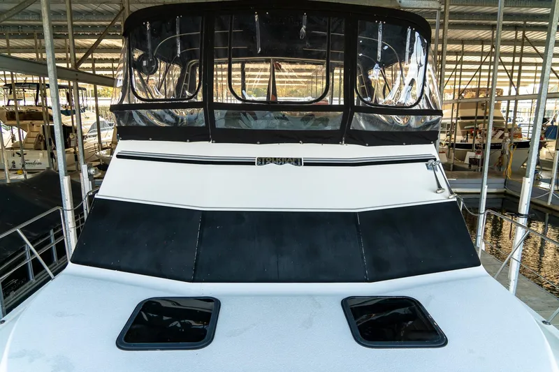 Slide: The Image of 1997 Harbor Master Stolkraft boat docked in a marina, featuring a covered upper deck. - 38