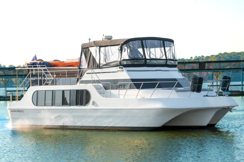 Slide: The Image of 1997 Harbor Master Stolkraft boat docked on calm water, featuring a sleek design. - 4