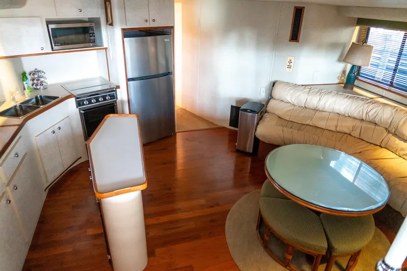 Slide: The Image of 1997 Harbor Master Stolkraft interior with kitchen, dining area, and cozy seating. - 40