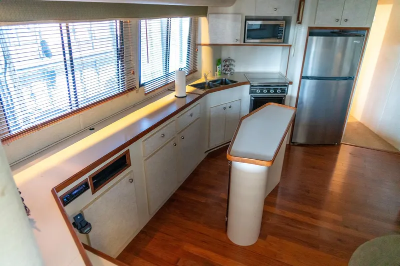 Slide: The Image of Modern kitchen interior of 1997 Harbor Master Stolkraft boat with wooden flooring. - 45