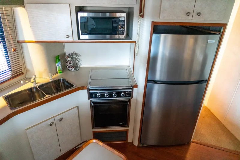 Slide: The Image of 1997 Harbor Master Stolkraft kitchen with stainless steel appliances and dual sink. - 46