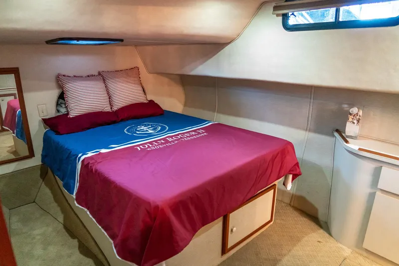 Slide: The Image of Cozy bedroom in 1997 Harbor Master Stolkraft boat with nautical-themed bedding. - 48