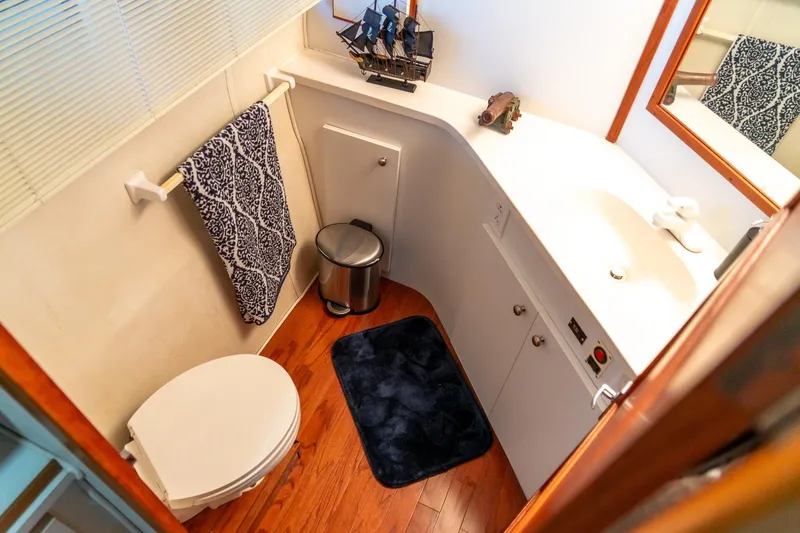 Slide: The Image of Bathroom interior of 1997 Harbor Master Stolkraft with wooden flooring and nautical decor. - 51