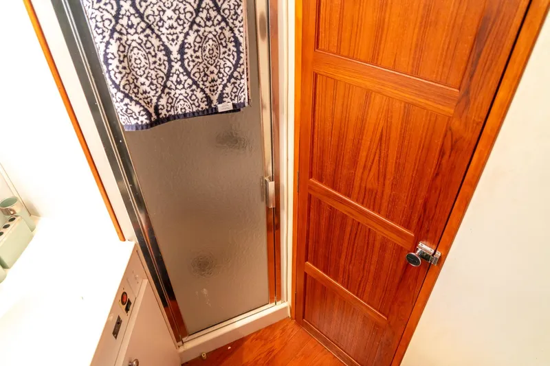 Slide: The Image of 1997 Harbor Master Stolkraft bathroom with wooden door and patterned towel. - 52