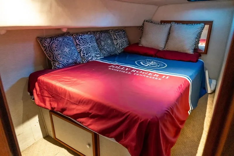 Slide: The Image of Cozy cabin bedroom in 1997 Harbor Master Stolkraft with decorative pillows and nautical bedding. - 53