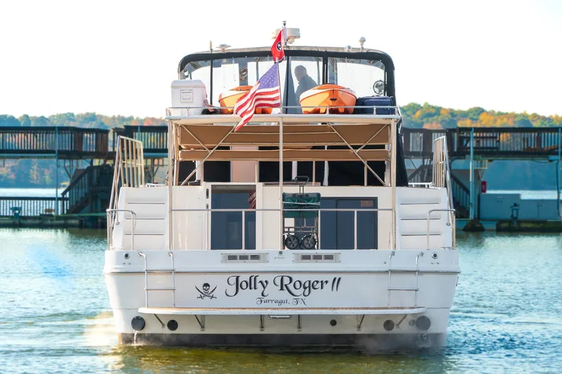 Slide: The Image of 1997 Harbor Master Stolkraft boat "Jolly Roger II" on water with American flag. - 7