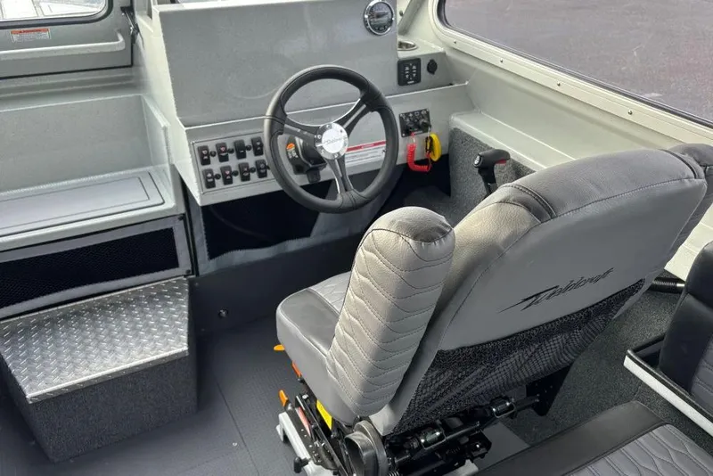 Slide: The Image of Interior of 2026 Weldcraft 220 Ocean King boat, featuring steering wheel and control panel. - 5