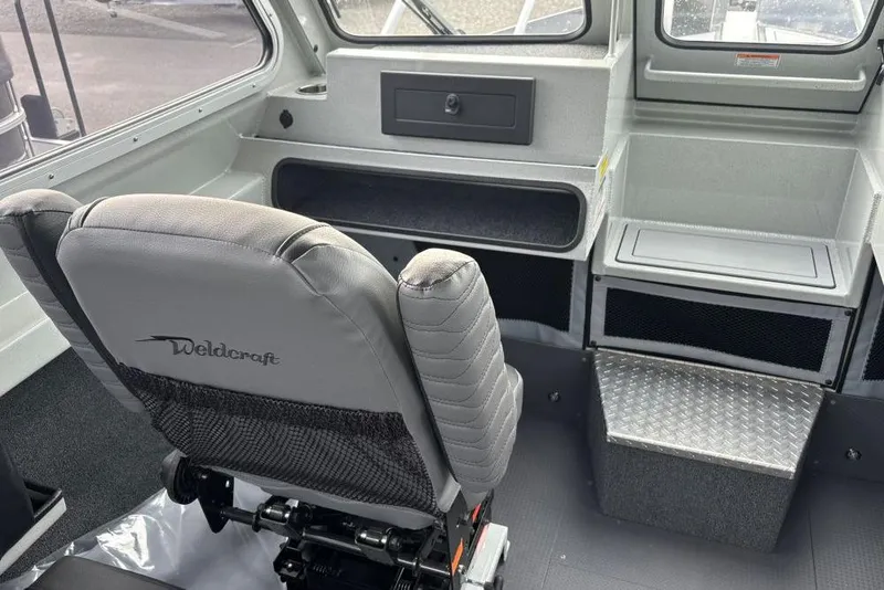 Slide: The Image of Interior of 2026 Weldcraft 220 Ocean King boat with seating and storage compartments. - 6