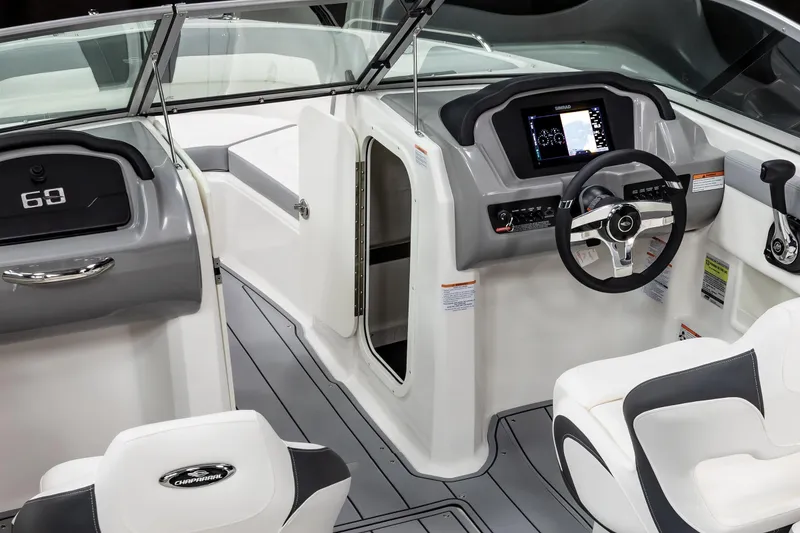 Slide: The Image of 2026 Chaparral 23 SSi boat displayed indoors on blue carpet. - 31