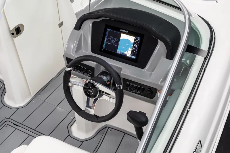 Slide: The Image of Interior view of 2026 Chaparral 23 SSi boat, featuring modern dashboard and seating. - 33
