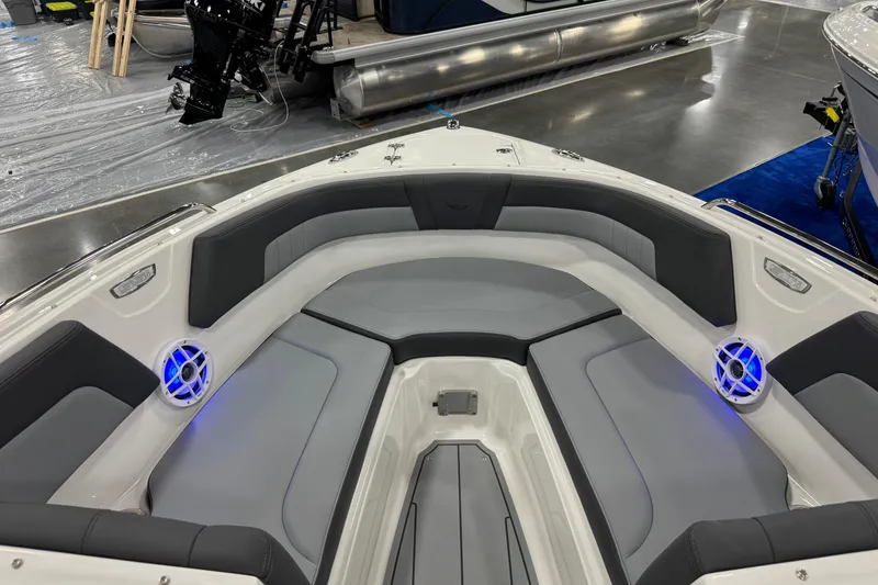 Slide: The Image of 2026 Chaparral 23 SSi boat interior with gray seating and blue-lit speakers. - 43