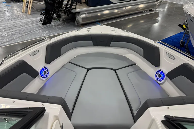 Slide: The Image of 2026 Chaparral 23 SSi boat interior with gray seating and blue-lit speakers. - 44