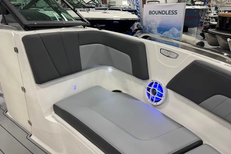 Slide: The Image of 2026 Chaparral 23 SSi boat interior with gray seating and blue LED lighting. - 45
