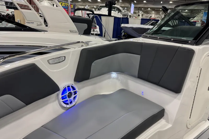 Slide: The Image of 2026 Chaparral 23 SSi boat interior with gray seating and blue LED lighting. - 46