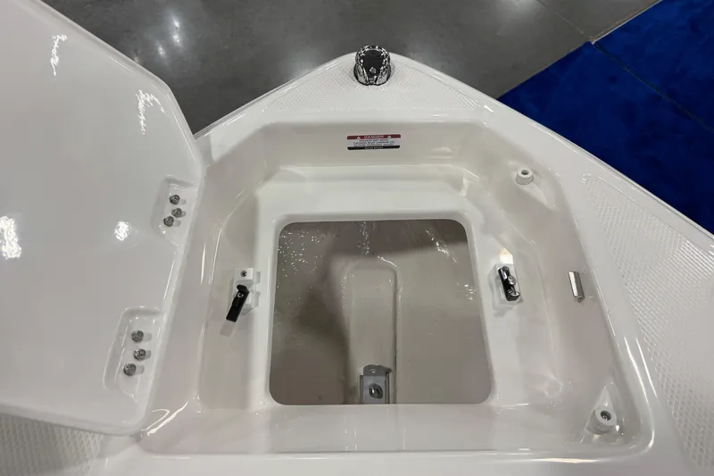 Slide: The Image of Open storage compartment on 2026 Chaparral 23 SSi boat, featuring sleek white interior design. - 47