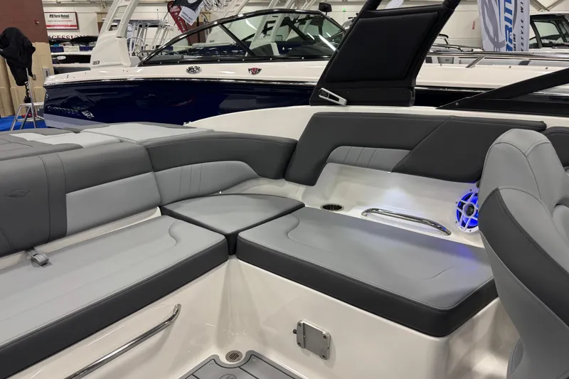 Slide: The Image of 2026 Chaparral 23 SSi boat interior with gray seating and blue LED speaker. - 48
