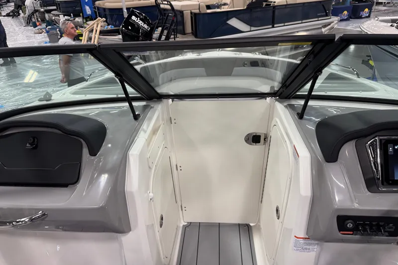 Slide: The Image of 2026 Chaparral 23 SSi boat interior with sleek dashboard and modern design. - 57