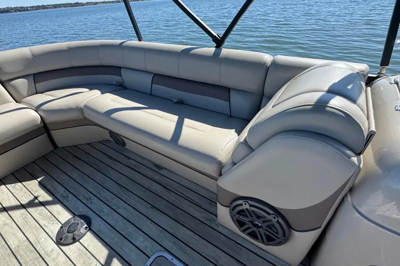 Slide: The Image of Luxurious seating on 2018 Trifecta SS 27RFE UDS XR pontoon boat by the water. - 10