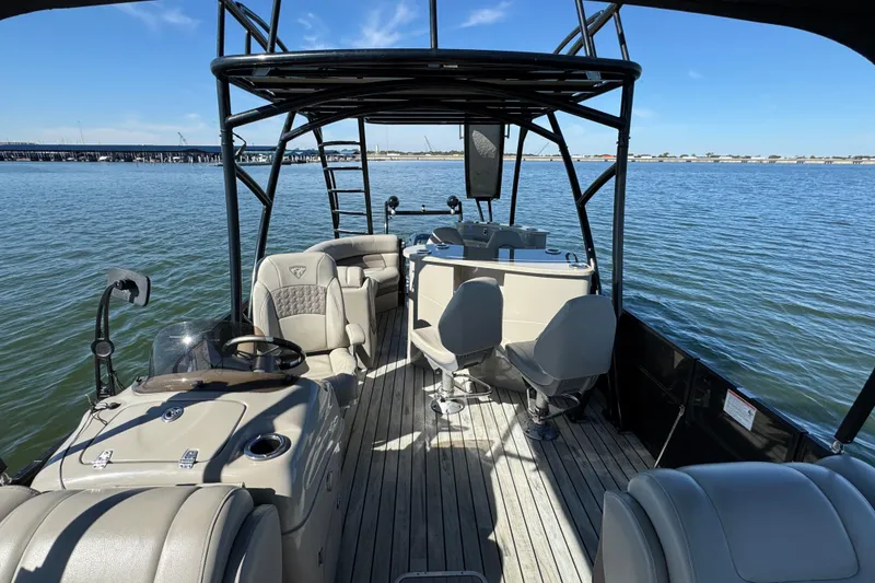 Slide: The Image of 2018 Trifecta SS 27RFE UDS XR pontoon boat interior on calm water. - 11