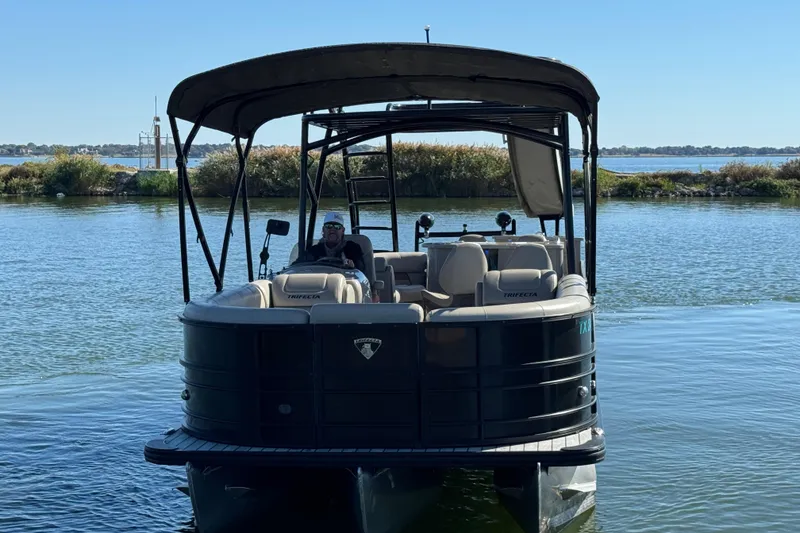 Slide: The Image of 2018 Trifecta SS 27RFE UDS XR pontoon boat on a serene lake. - 2
