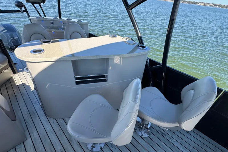Slide: The Image of 2018 Trifecta SS 27RFE UDS XR boat interior with seating and table on water. - 20
