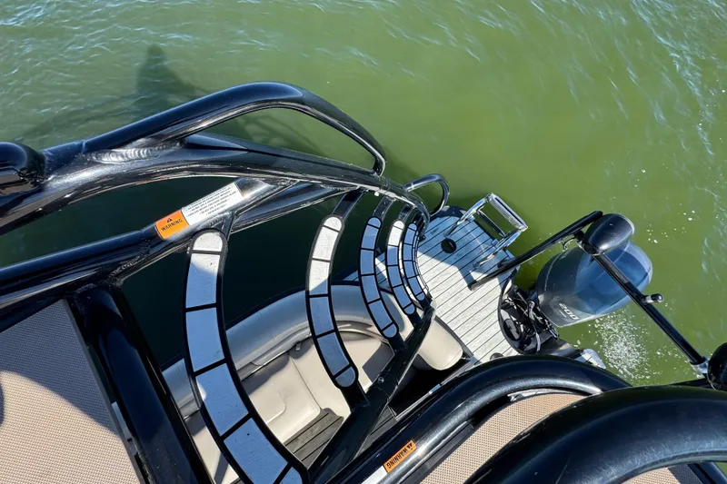 Slide: The Image of 2018 Trifecta SS 27RFE UDS XR boat with sleek design on green water. - 27