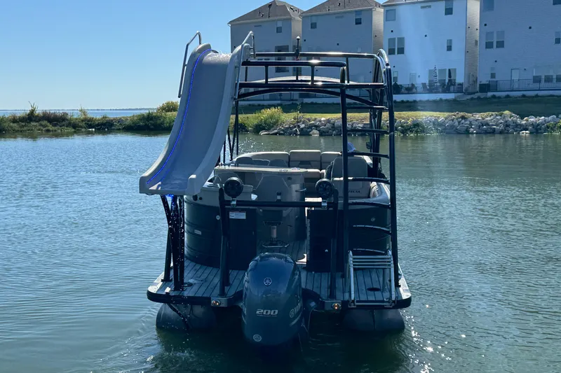 Slide: The Image of 2018 Trifecta SS 27RFE UDS XR pontoon boat with slide on a calm lake. - 6