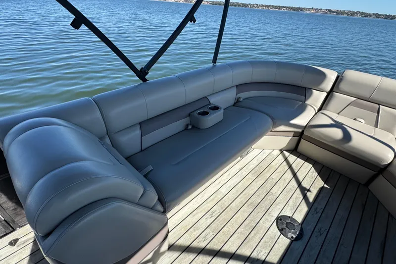 Slide: The Image of Luxurious seating on 2018 Trifecta SS 27RFE UDS XR pontoon boat, overlooking serene water. - 9