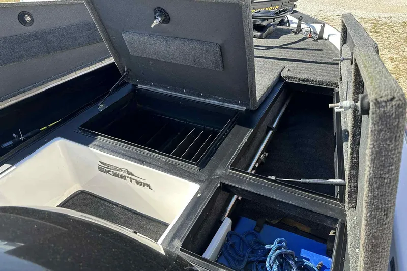 Slide: The Image of 2003 Skeeter ZX200 boat storage compartments with open hatches and visible equipment. - 11