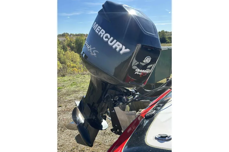 Slide: The Image of 2003 Skeeter ZX200 with Mercury OptiMax Pro XS outboard motor in scenic outdoor setting. - 13