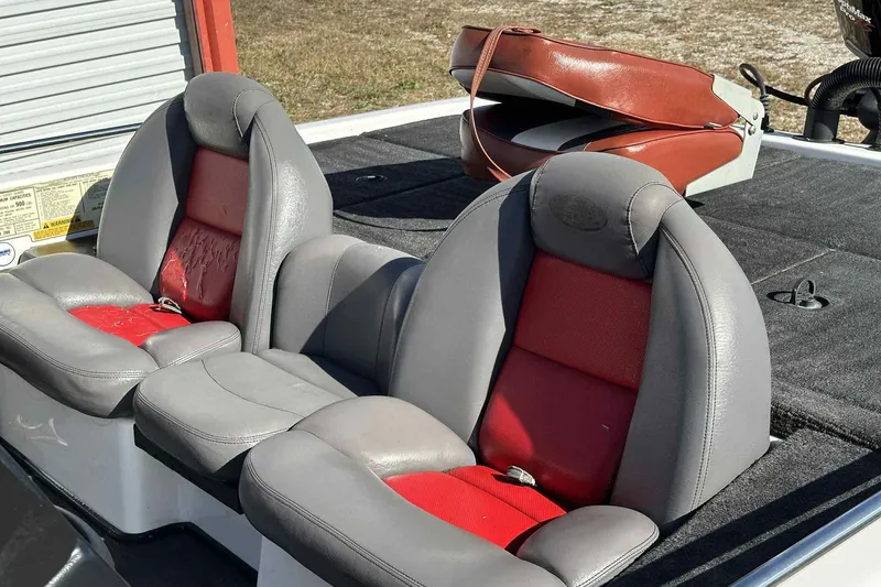 Slide: The Image of 2003 Skeeter ZX200 boat seats with red and gray upholstery, showing wear and tear. - 21