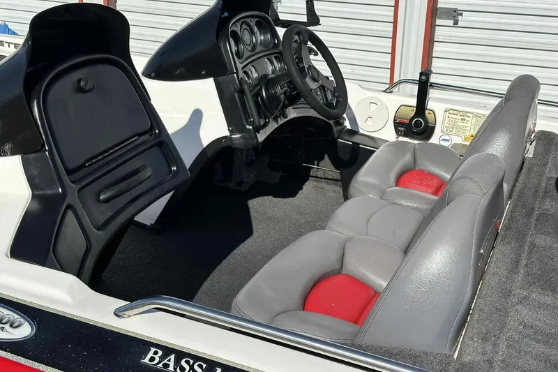 Slide: The Image of 2003 Skeeter ZX200 boat interior with gray and red seats, steering wheel, and control panel. - 24