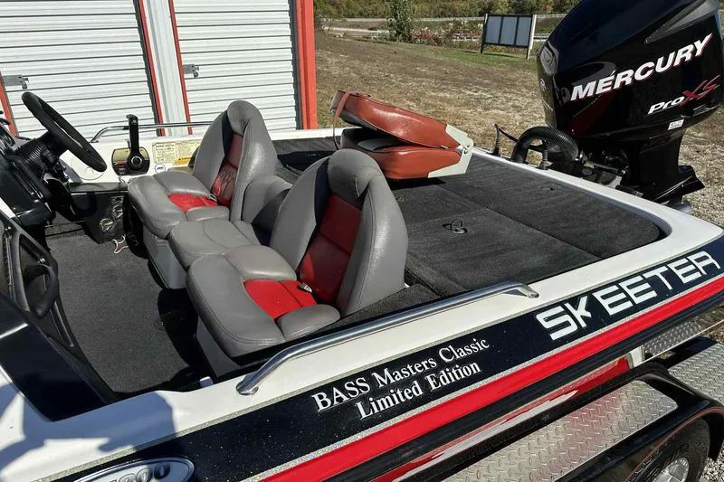 Slide: The Image of 2003 Skeeter ZX200 Bass boat with Mercury Pro XS engine, featuring red and gray seating. - 25