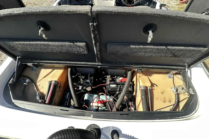 Slide: The Image of 2003 Skeeter ZX200 boat engine compartment with open hatch, showing internal components and wiring. - 26
