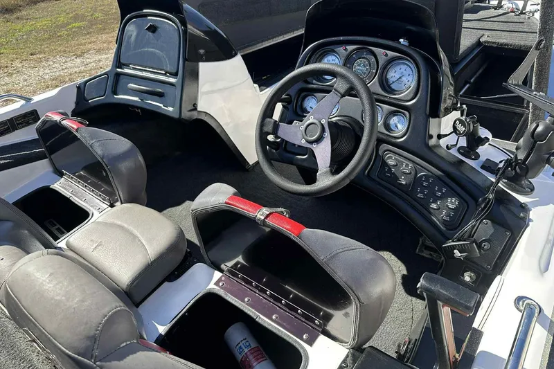 Slide: The Image of 2003 Skeeter ZX200 boat interior with steering wheel and dashboard controls. - 3
