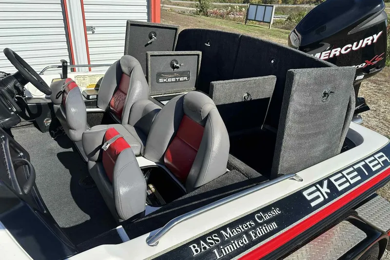 Slide: The Image of 2003 Skeeter ZX200 boat interior with red and gray seats, storage compartments, and Mercury engine. - 30